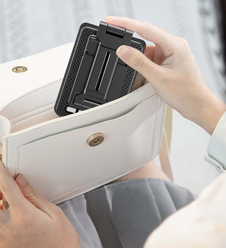 Smartphone broadcast stand with Bluetooth speaker being placed into a handbag for easy portability.