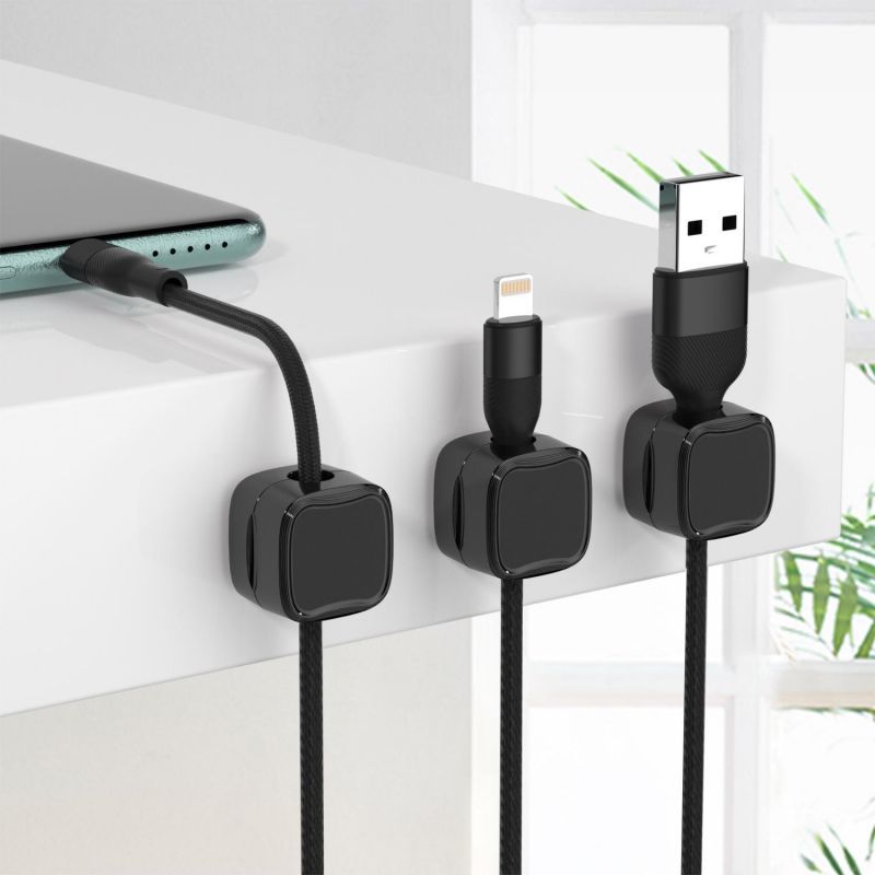 Black cable clips holding USB and lightning cables on desk edge - Efficient Office